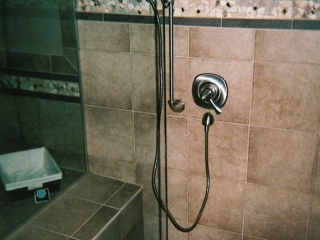 shower remodel with new tile and handheld shower tap