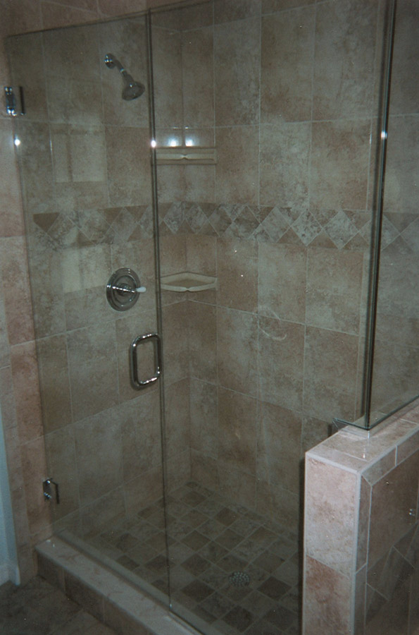 shower remodel with new tile and glass doors